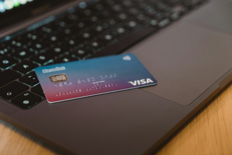 Person using a portable payment card reader to accept a credit card at a small shop counter