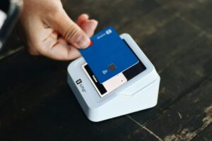Business owner reviews card payment receipts beside a payment terminal and monthly processing statement.